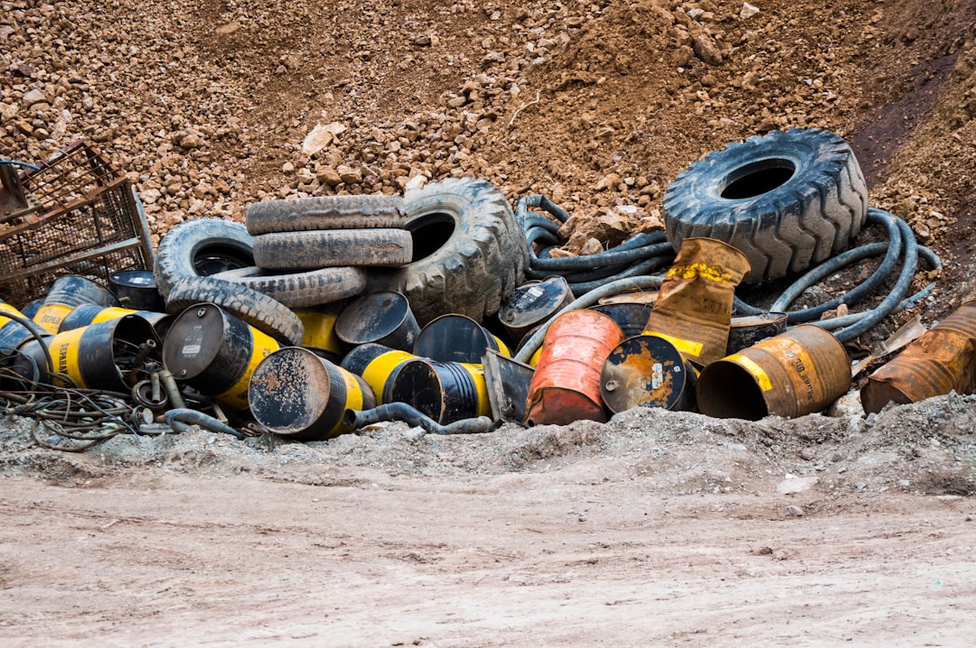 a-pile-of-old-tires-sitting-in-the-mud-0wherlofq60